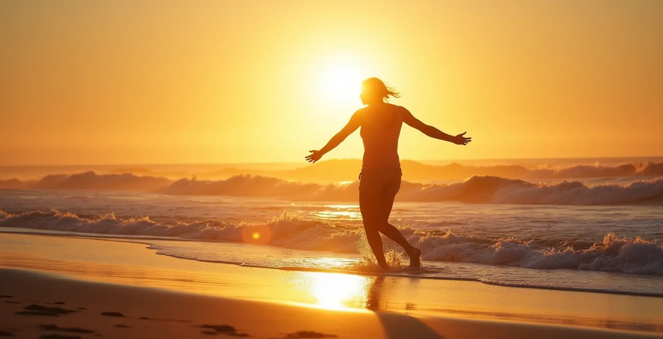 Silhouette walking into Pacific Ocean waves at golden hour sunset